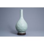 A Chinese monochrome celadon vase with underglaze relief design, Qianlong mark, 19th C.