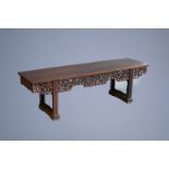 A Chinese wooden table with reticulated floral design, 19th/20th C.