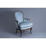 A French Louis XV armchair 'en cabriolet' with floral design and velvet upholstery, stamped E. Meuni