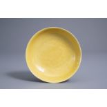 A Chinese monochrome yellow incised 'dragon' saucer dish, Daoguang mark and of the period