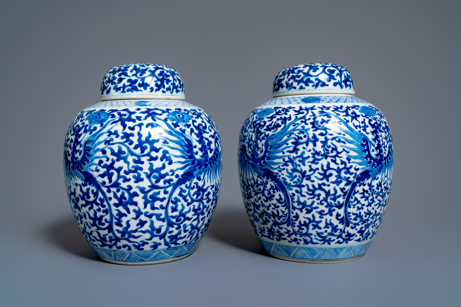 A pair of Chinese blue and white 'phoenix' jars and covers with floral design, Kangxi mark, 19th C. - Image 5 of 7