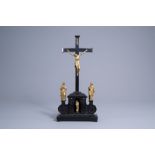 A German ebony and ebonised wooden crucifix with a gilt bronze Holy Family, presumably Augsburg, 17t