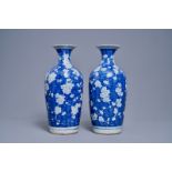 A pair of Chinese blue and white 'prunus on cracked ice' vases, 19th C.