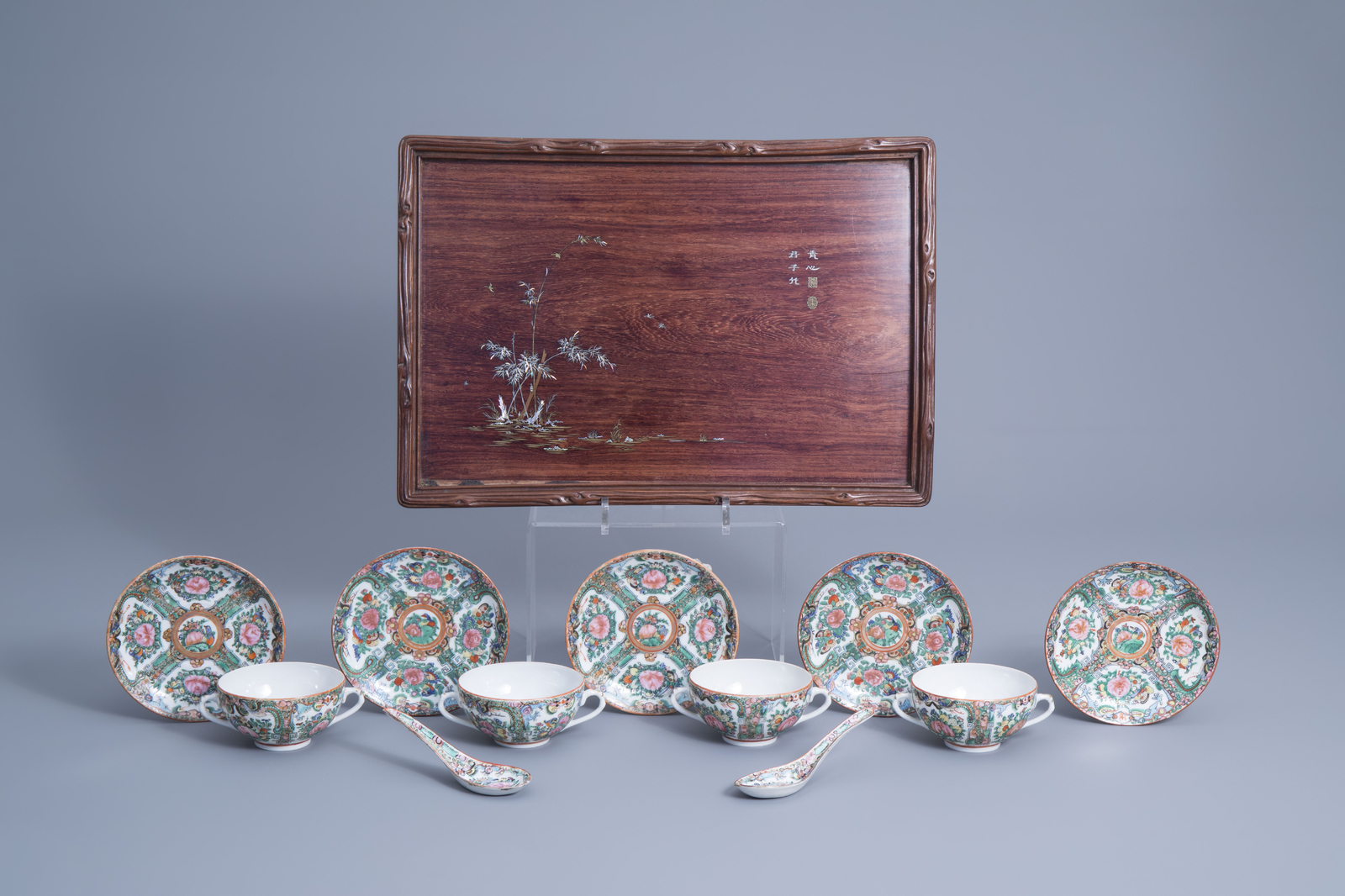 Four Chinese Canton famille rose cups, five saucers, two spoons and a wooden tray with inlay, 20th C