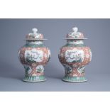 A pair of Chinese famille verte vases and covers with floral design, 19th/20th C.