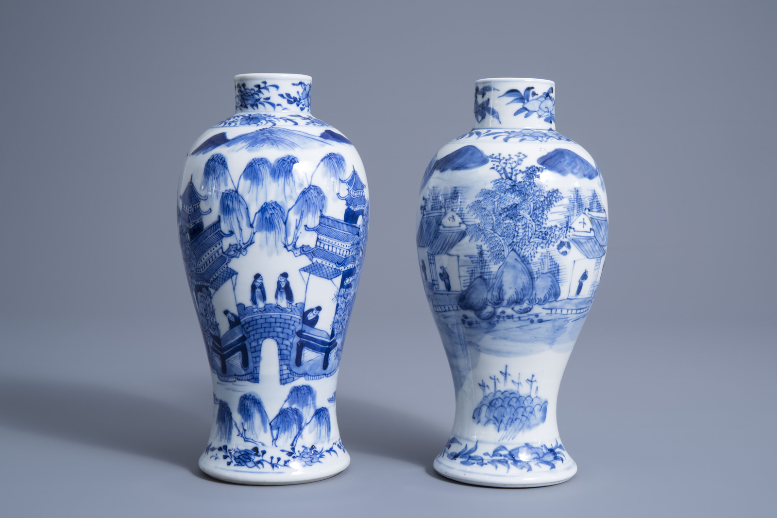 Two Chinese blue and white baluster vases with figures in a river landscape, Kangxi mark, 19th C.