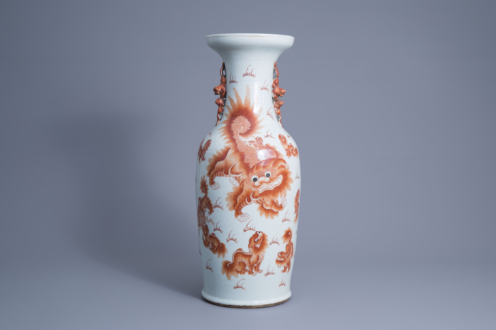 A Chinese iron red vase with Buddhist lions, 19th C.