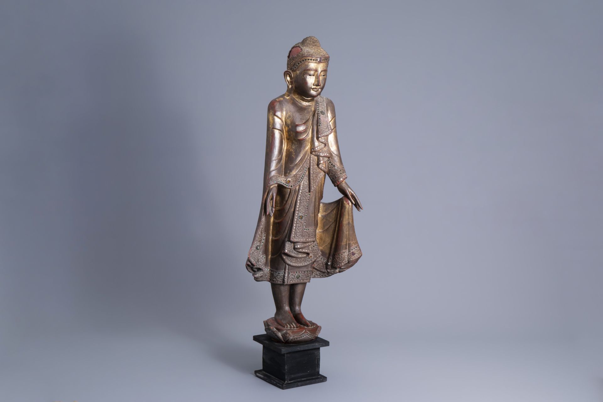 A tall inlaid gilt wood figure of a standing Buddha, Burma or Thailand, 19th/20th C.