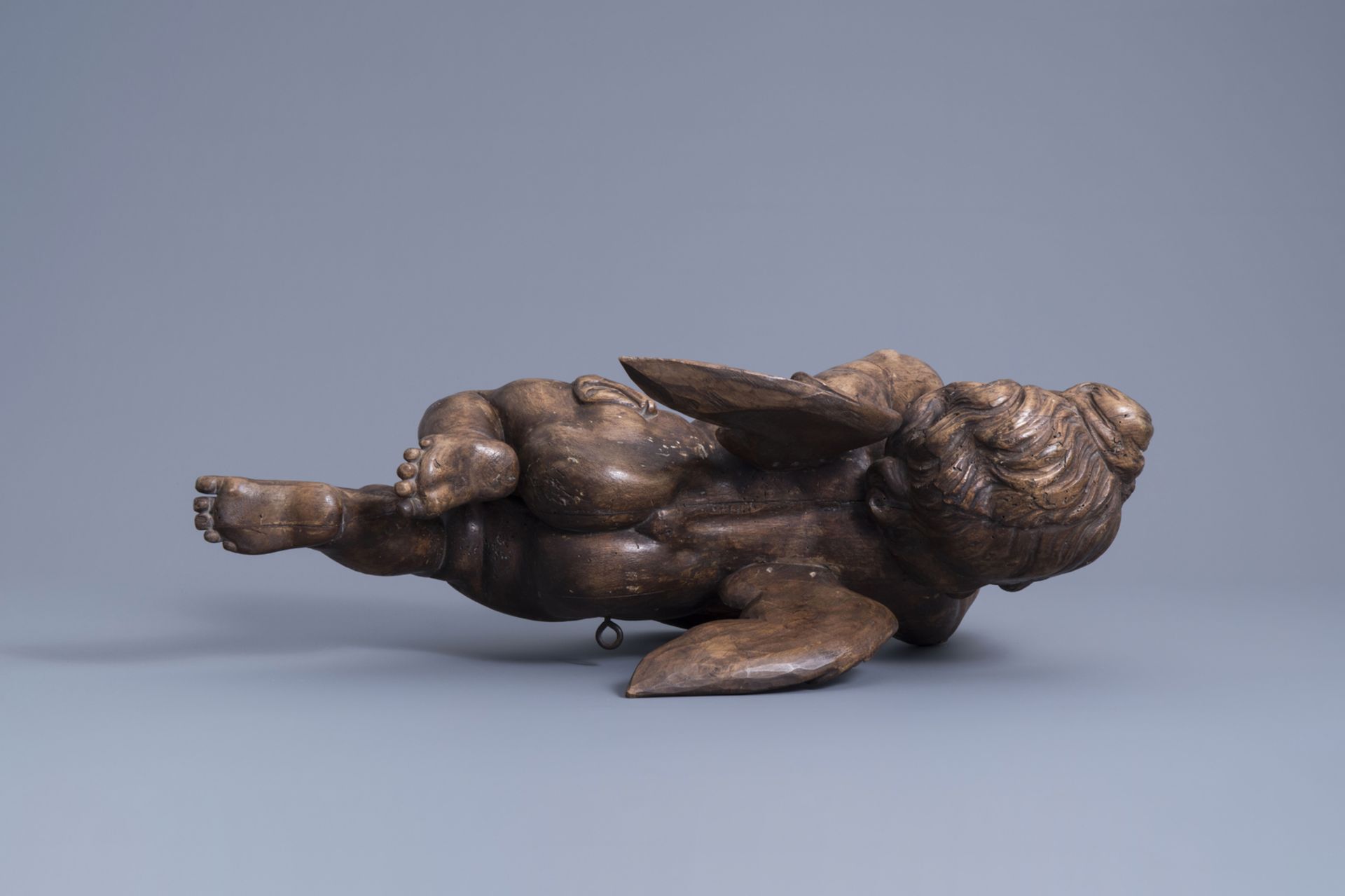 A patinated carved wooden figure of a putto, Southern Netherlands, 18th C. - Image 6 of 7