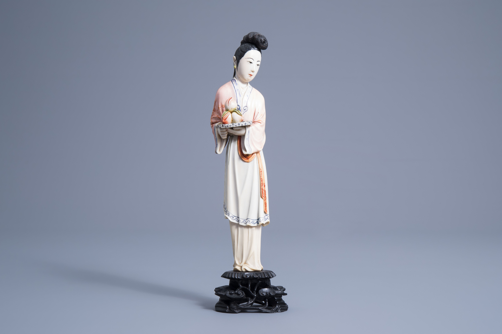 A Chinese polychrome ivory figure of a lady holding a tray of peaches, first half 20th C. - Image 2 of 7
