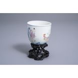 A Chinese famille rose 'boy and rooster' cup on wooden stand, Qianlong mark, 20th C.