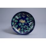 A Chinese dark blue ground 'chrysanthemum' dish, Kangxi mark, 19th/20th C.