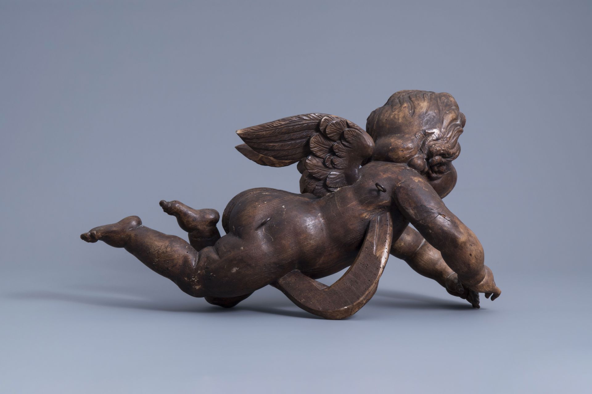 A patinated carved wooden figure of a putto, Southern Netherlands, 18th C. - Image 4 of 7