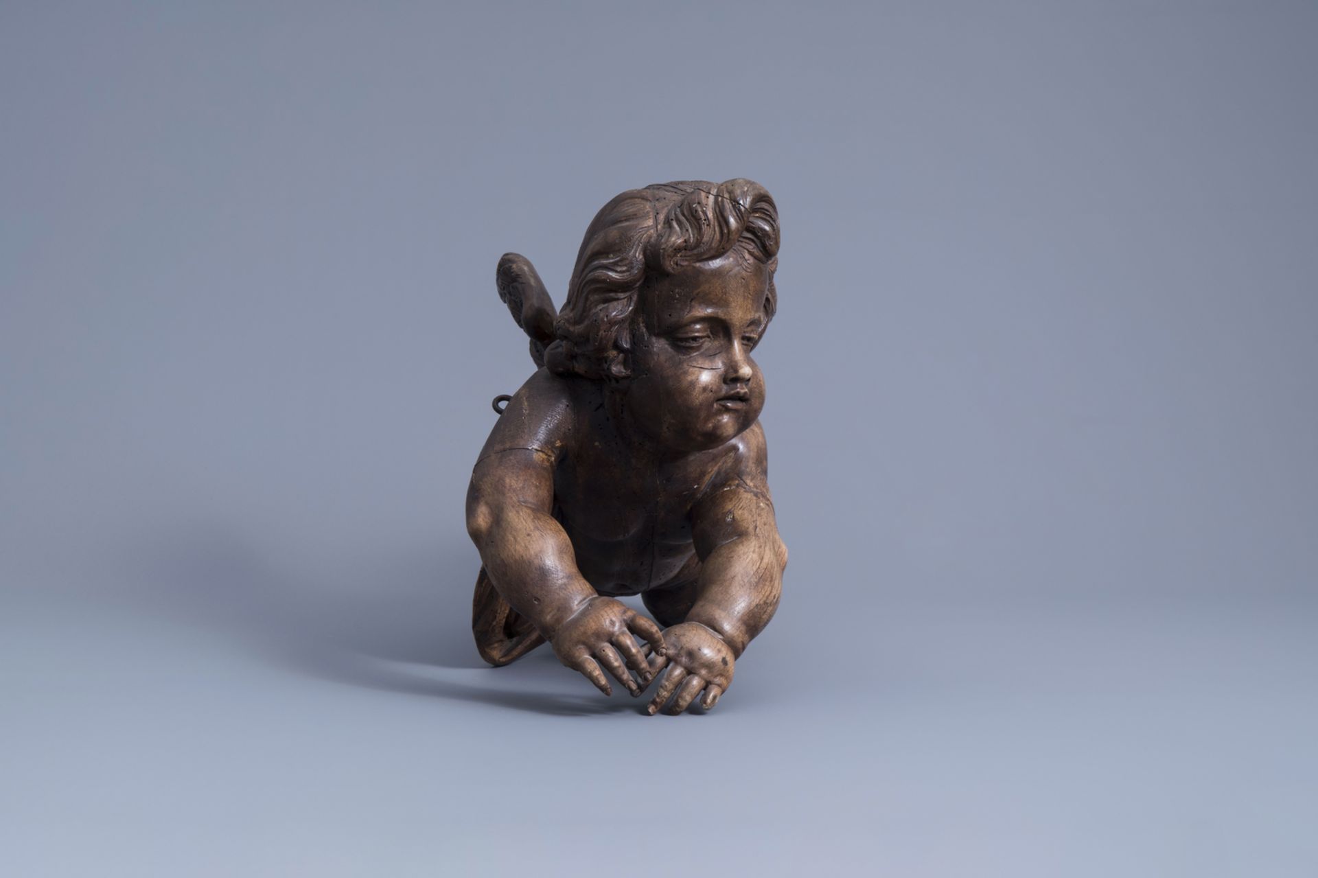 A patinated carved wooden figure of a putto, Southern Netherlands, 18th C. - Image 3 of 7