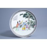 A Chinese famille rose dish with figures in a garden, Republic, 20th C.