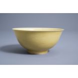 A Chinese monochrome yellow bowl with incised dragon design, Qianlong mark, 19th/20th C.