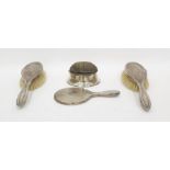 Two silver-backed dressing table brushes, a dressing table mirror and a pin cushion (4)