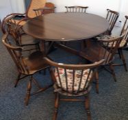 Dark Ercol drop-leaf dining table and eight chairs, four folding beech kitchen chairs, a rush seated