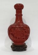 Chinese carved cinnabar lacquer vase, ball and shaft shaped with shaped panels of carved flowers