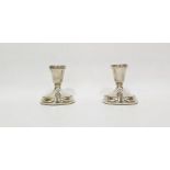 Pair of weighted silver candlesticks