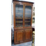 Late 19th century oak bookcase, moulded pediment above two glazed doors enclosing shelves on a