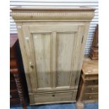 Late 19th/early 20th century pine single door wardrobe with drawer under, raised on turned supports,