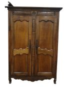 19th century two-door armoire, the moulded pediment above two panelled doors, the whole with