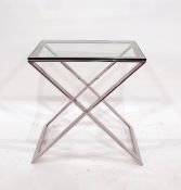 Oka  coffee table with glass top and chrome base of X-shaped from