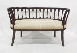 Two seater settee, the curved top rail above wheatsheaf style supports, ovoid seat and swept