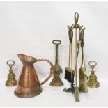 Three brass doorstops, fireside companion set and a copper ewer