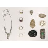 Jet-type oval floral brooch, a silver-coloured metal filigree pendant, a marcasite and jade-coloured