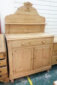 19th century pine dresser with shaped backboard above single drawer and two cupboard doors, raised