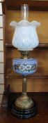 Victorian oil lamp with glass shade and pale blue opaque glass well painted with daisies, on a brass