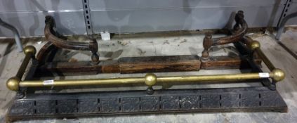 Brass and cast iron fire curb and a carved wooden fire curb (2)