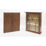 Mahogany two door wall hanging cupboard together with a modern mahogany wall hanging display cabinet