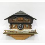 Swiss made three-train cuckoo and musical clock based on an alpine chalet