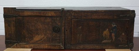 Continental oak two-door cupboard/chest, the right hand door with painted figural decoration and