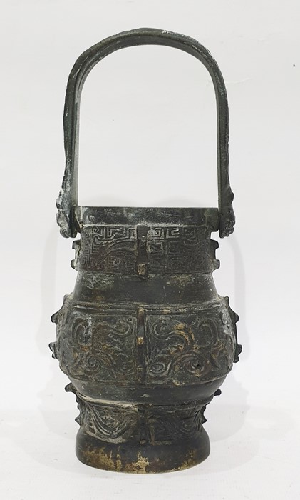 Antique Chinese bronze vase of archaic form with loop handle, embossed panels, 22cm high