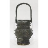 Antique Chinese bronze vase of archaic form with loop handle, embossed panels, 22cm high