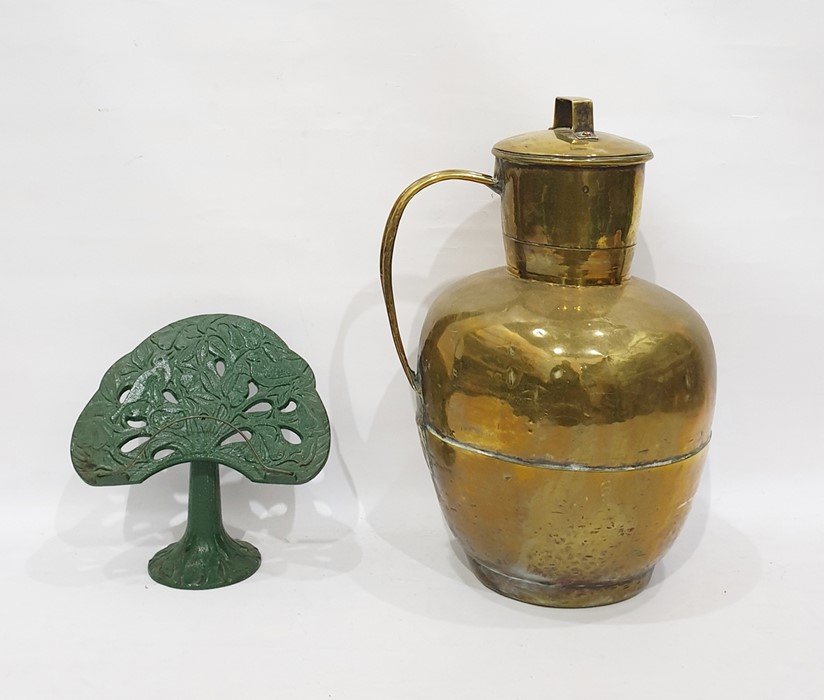 Large brass leaded jar and a cookery book rest in green iron