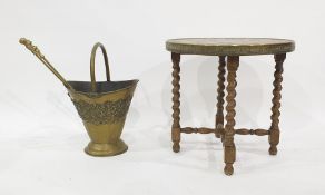 Circular brass topped coffee table on folding base with barley twist supports, brass coal bucket and