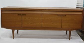 Alfred Cox teak sideboard, the rectangular top with four drawers, four cupboard doors and square