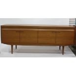 Alfred Cox teak sideboard, the rectangular top with four drawers, four cupboard doors and square