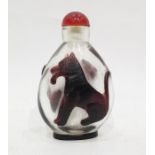 Teardrop shaped snuff bottle decorated with Lion and Wolf in ruby red