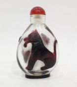 Teardrop shaped snuff bottle decorated with Lion and Wolf in ruby red