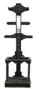 Victorian gothic style coat and umbrella stand with carved decoration, central rectangular mirror,