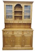 Modern pine dresser, the ogee moulded pediment above two glazed doors flanking central open