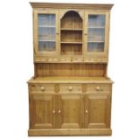 Modern pine dresser, the ogee moulded pediment above two glazed doors flanking central open