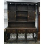Oak dresser in the 18th century style with various shelves, two cupboards to the top section and the
