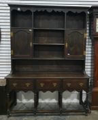 Oak dresser in the 18th century style with various shelves, two cupboards to the top section and the